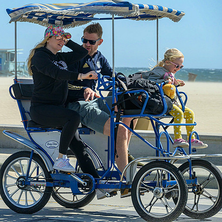 Four wheeling family bicycle on the Santa Monica Boardwalk